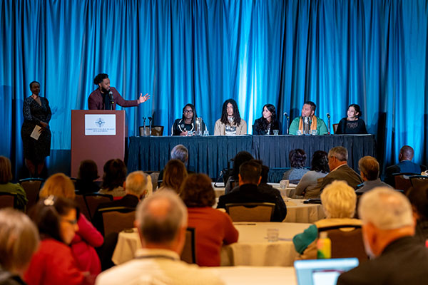 A group of community college students participating in a panel discussion at a conference.